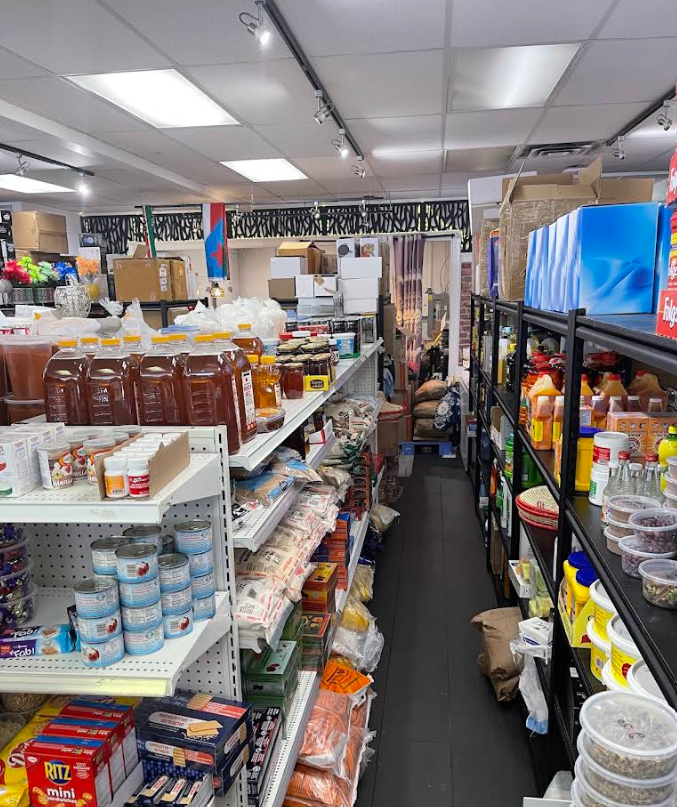 Store shelves stocked with palm oil, packaged staples and pantry goods